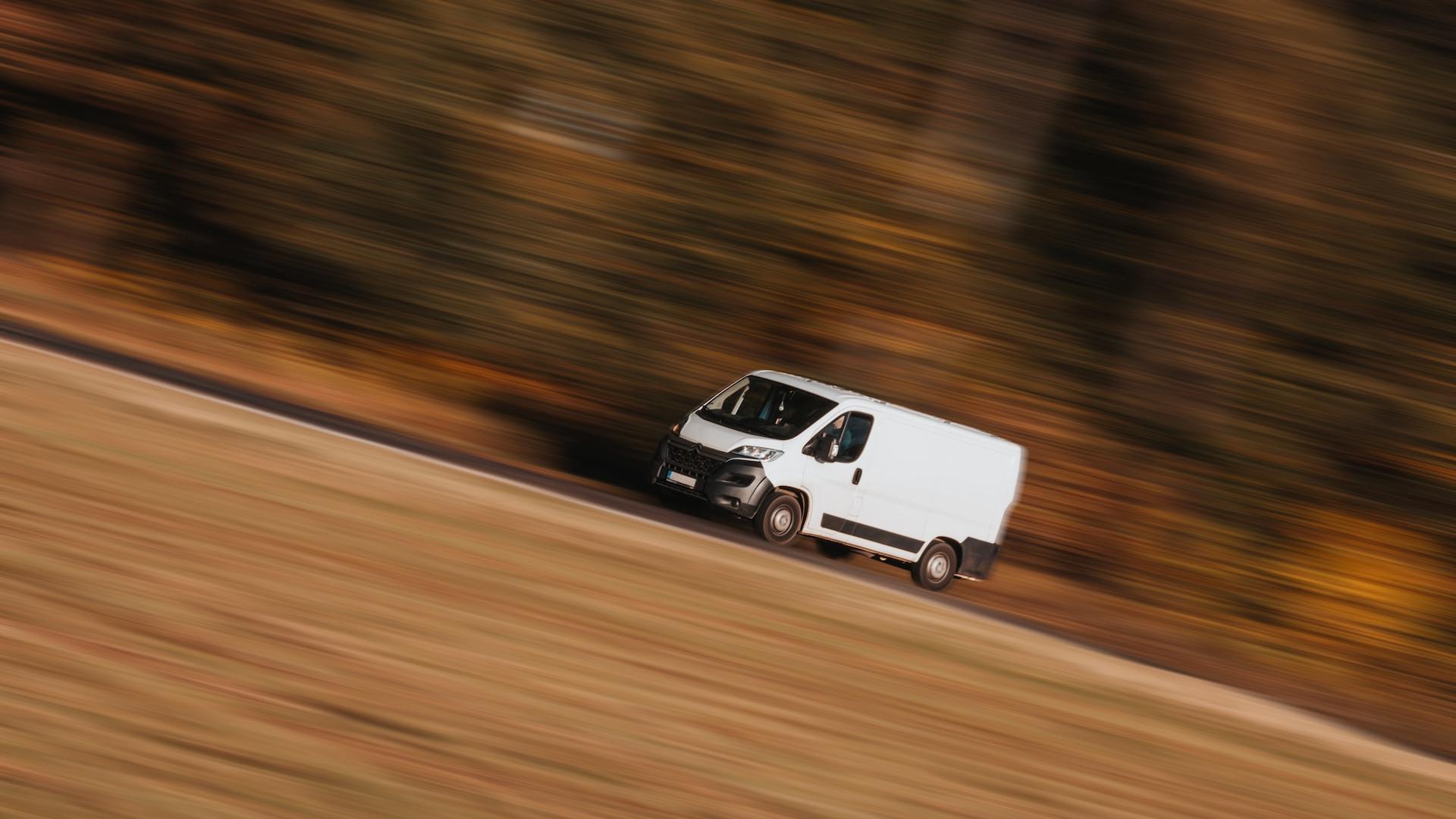 a white car driving on a road